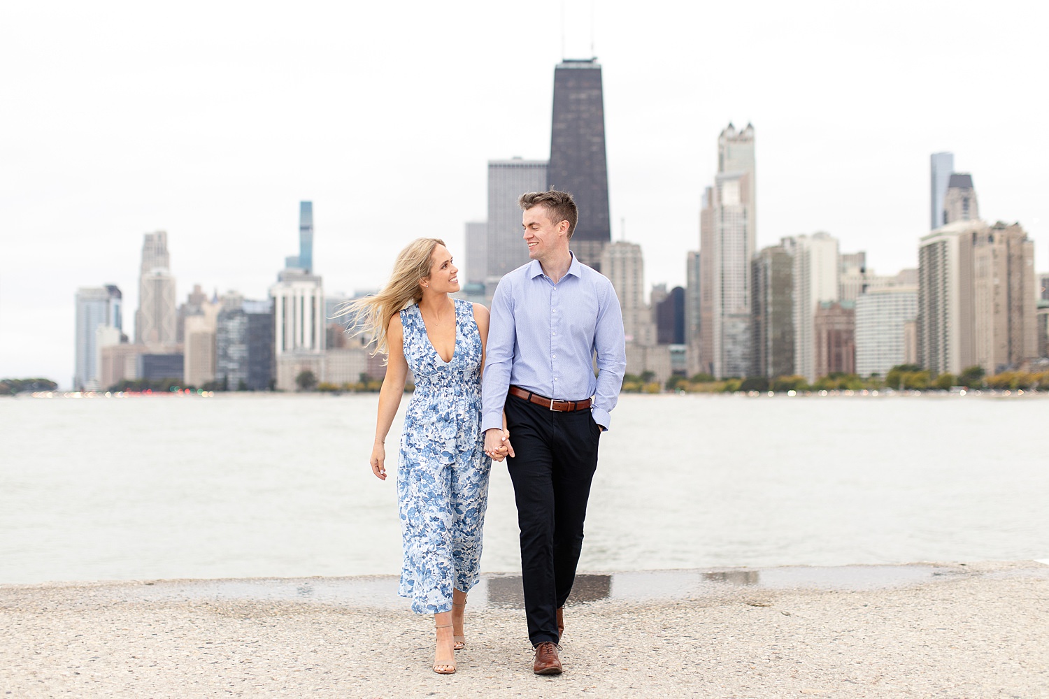 Couple walks by North Avenue beach for Chicago engagement photos